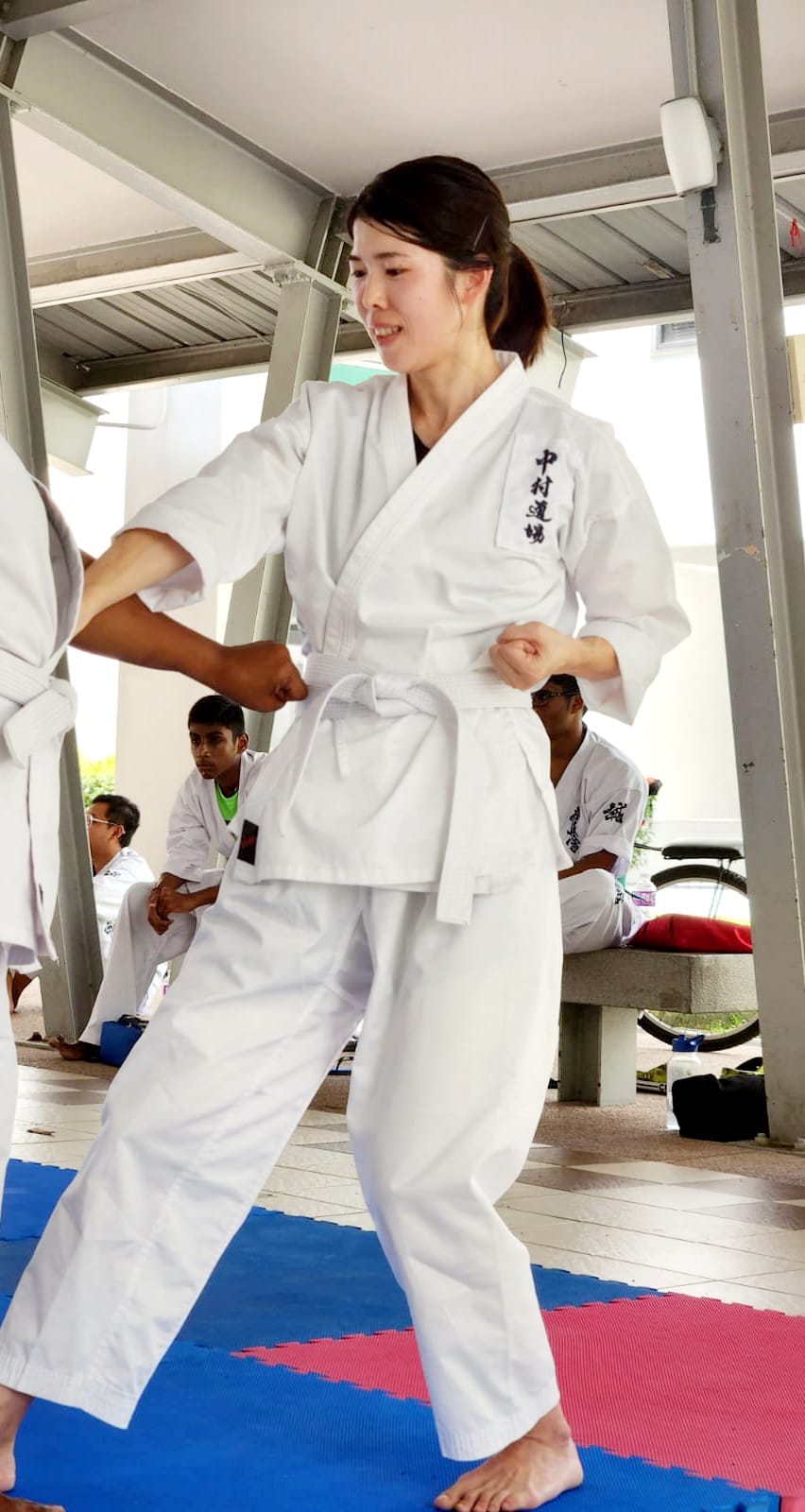 Female karateka in a strong defensive stance