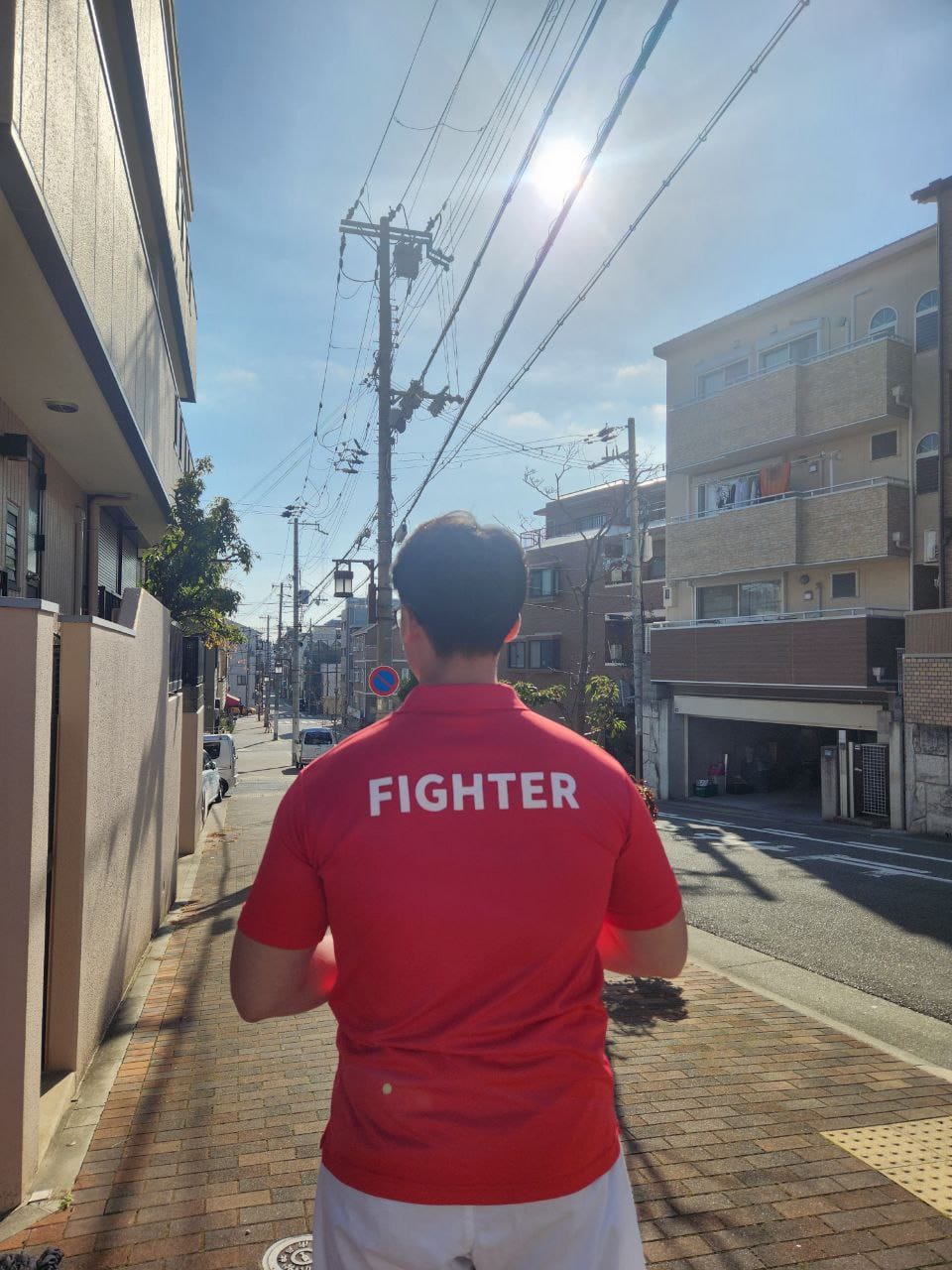 IKO Nakamura fighter walking under the sun in Japan